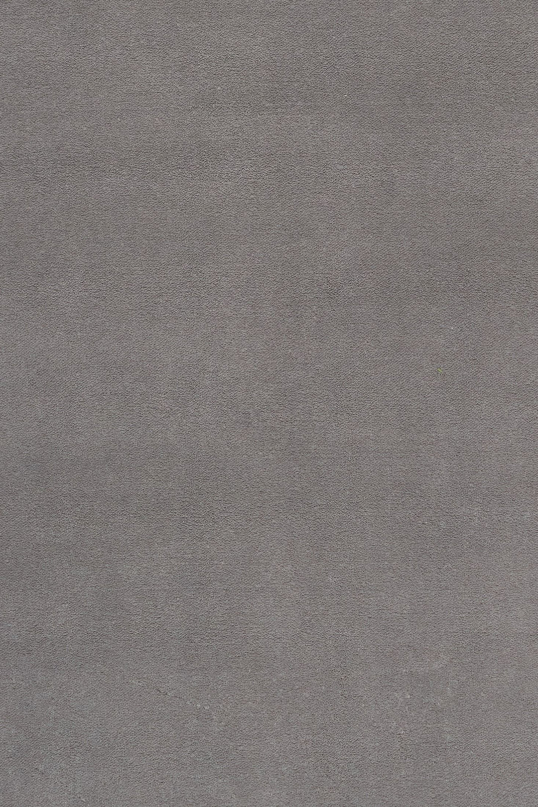 Close-up fabric swatch of a grey rug showing its soft texture.