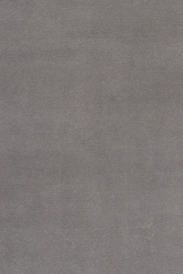 Close-up fabric swatch of a grey rug showing its soft texture.