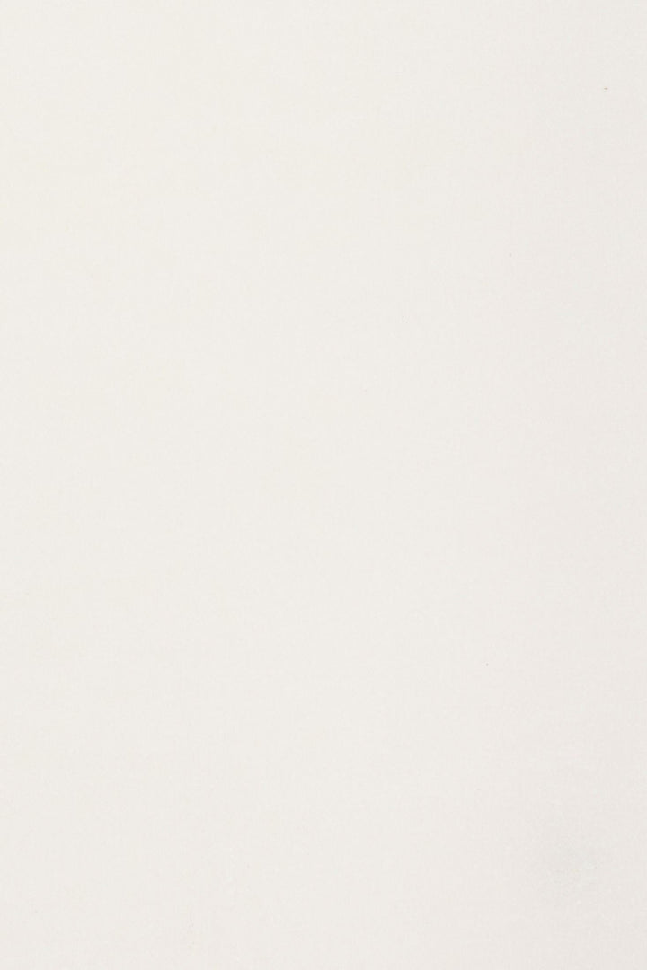 Close-up fabric swatch of a white rug showing its soft texture.