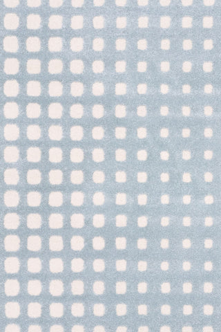 Close-up of blue rug with soft white square pattern.