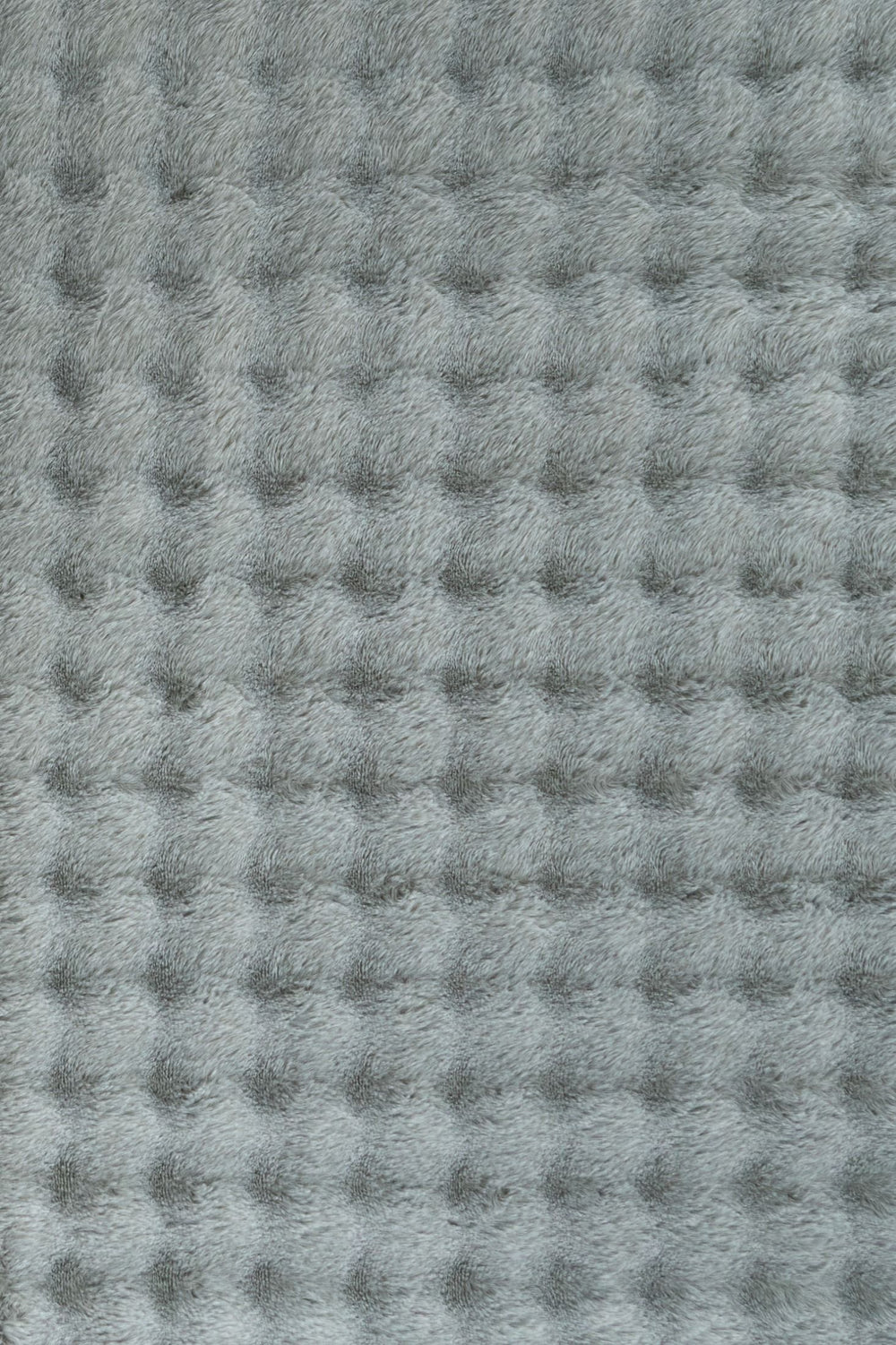 Full rectangular light grey textured fluffy rug on plain background.