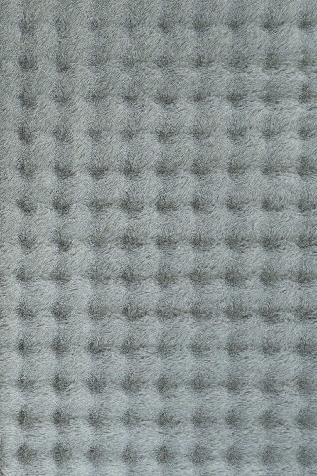 Full rectangular light grey textured fluffy rug on plain background.
