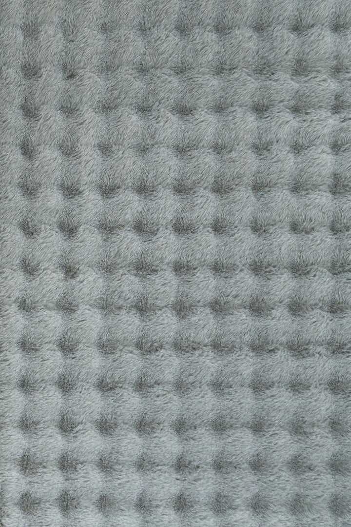 Full rectangular light grey textured fluffy rug on plain background.