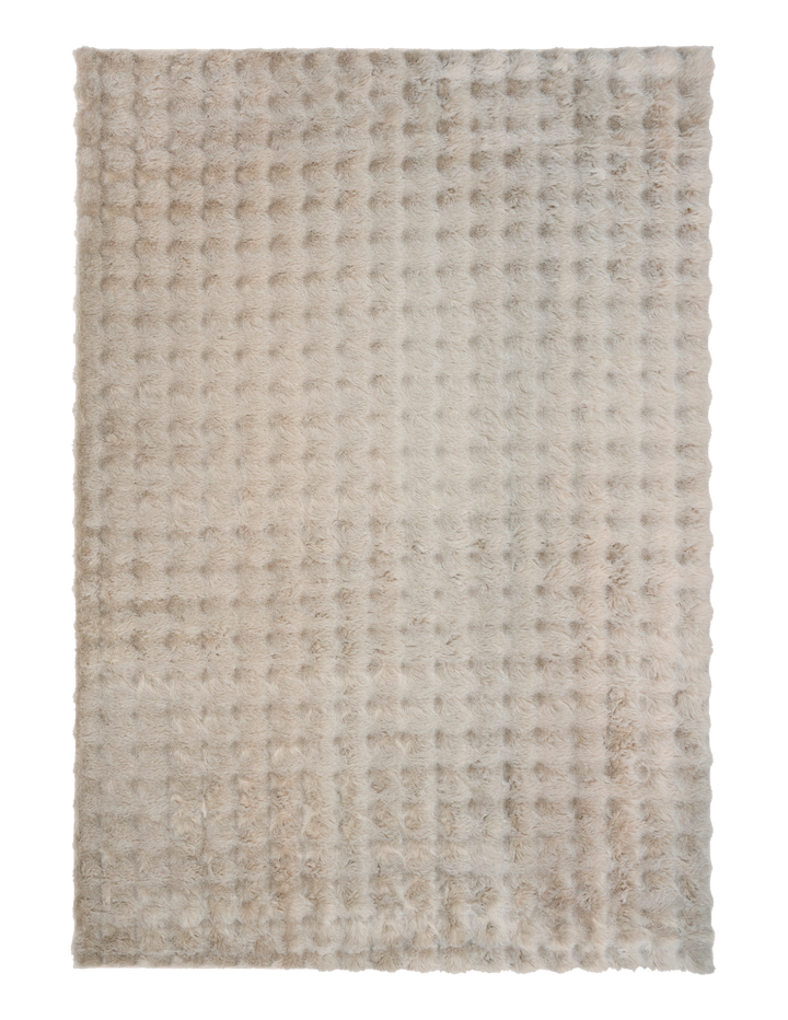 Full view of light beige textured fluffy rug on plain background.
