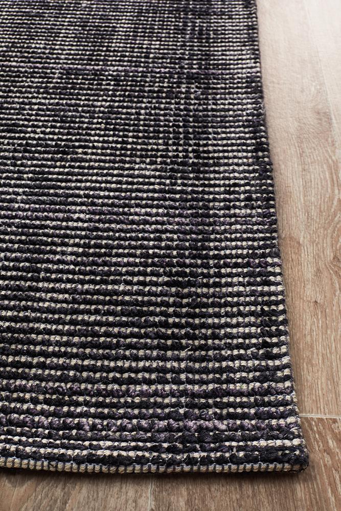Allure Black cotton rayon rug on hardwood floor showing natural fiber texture