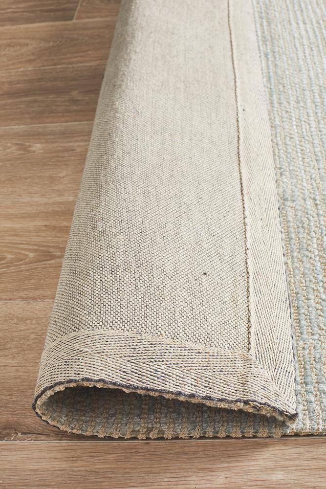 Allure Sky area rug placed in modern living room showing the cotton backing. Trends Rugs